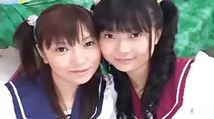 Two Asian schoolgirls simultaneous blowjob